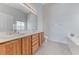 Primary bathroom features double sinks, large mirror and combination tub and shower at 7892 Villa Salsa Ave, Las Vegas, NV 89131