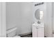 Simple half bath with a white single vanity and a modern toilet, designed for practical use and functionality at 7892 Villa Salsa Ave, Las Vegas, NV 89131