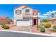 Charming two-story home boasts colorful accents, landscaped yard, and a two-car garage at 7892 Villa Salsa Ave, Las Vegas, NV 89131
