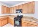 Kitchen with wood cabinets, granite counters, and stainless steel appliances at 7892 Villa Salsa Ave, Las Vegas, NV 89131