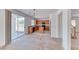 Open kitchen with wood cabinets, black appliances, and sliding doors to the backyard at 7892 Villa Salsa Ave, Las Vegas, NV 89131