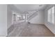 Open-concept living area with carpet, neutral tones, stairs, and natural light at 7892 Villa Salsa Ave, Las Vegas, NV 89131