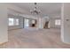 Expansive living area features carpet, view to kitchen, stairs, and plenty of natural light at 7892 Villa Salsa Ave, Las Vegas, NV 89131