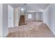 Spacious carpeted living room features stairs, neutral tones, and natural light at 7892 Villa Salsa Ave, Las Vegas, NV 89131