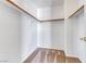 Empty walk-in closet with wooden clothes racks installed and clean patterned carpet at 7892 Villa Salsa Ave, Las Vegas, NV 89131