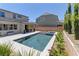 Stunning backyard with pool, spa, covered patio, and manicured landscaping at 8335 Beaten Path Ct, Las Vegas, NV 89166