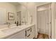 Bright bathroom featuring double sinks, quartz counters and modern fixtures at 8335 Beaten Path Ct, Las Vegas, NV 89166