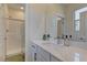 Bathroom featuring a walk-in shower with a glass door, modern fixtures, and a white vanity at 8335 Beaten Path Ct, Las Vegas, NV 89166