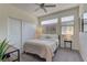 Cozy bedroom with neutral tones, closet, and plenty of natural light from windows at 8335 Beaten Path Ct, Las Vegas, NV 89166