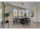 Dining room featuring a round table with seating, stylish chandelier, and sliding glass door access at 8335 Beaten Path Ct, Las Vegas, NV 89166