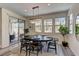 Bright dining room area with a modern chandelier, contemporary decor and natural lighting from the windows at 8335 Beaten Path Ct, Las Vegas, NV 89166
