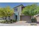 Charming home showcasing modern architecture, complemented by a well-maintained front yard and two-car garage at 8335 Beaten Path Ct, Las Vegas, NV 89166