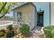 Charming entrance featuring a blue accent wall, stylish door, and professionally maintained landscaping at 8335 Beaten Path Ct, Las Vegas, NV 89166