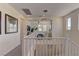 Hallway featuring a modern chandelier over the staircase leading to the upper level at 8335 Beaten Path Ct, Las Vegas, NV 89166