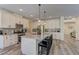 Modern kitchen featuring white cabinets, granite countertops, stainless appliances and an island with seating at 8335 Beaten Path Ct, Las Vegas, NV 89166