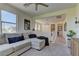 Stylish living room featuring a comfortable sectional sofa, ample natural light, and modern decor at 8335 Beaten Path Ct, Las Vegas, NV 89166