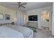 Spacious main bedroom with a large TV, ensuite bathroom, and plush carpet flooring at 8335 Beaten Path Ct, Las Vegas, NV 89166