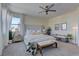 Bright and airy main bedroom with a tufted headboard, two benches, and lots of natural light at 8335 Beaten Path Ct, Las Vegas, NV 89166