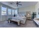 Bright main bedroom with plush carpet, a large bed, and multiple windows for plenty of natural light at 8335 Beaten Path Ct, Las Vegas, NV 89166