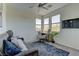 Bright office with comfortable sofa, computer, large windows, and a ceiling fan at 8335 Beaten Path Ct, Las Vegas, NV 89166