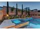 Beautiful pool featuring a spa, water feature, and privacy landscaping with accent lighting at 8335 Beaten Path Ct, Las Vegas, NV 89166