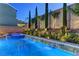 Resort-style pool with water features, a spa, and lush landscaping creating a private oasis at 8335 Beaten Path Ct, Las Vegas, NV 89166