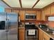 Updated kitchen with stainless steel appliances, oak cabinets, and a modern microwave at 8410 Eldora Ave # 1053, Las Vegas, NV 89117