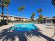 Community pool with palm trees and a blue sky at 8410 Eldora Ave # 1053, Las Vegas, NV 89117