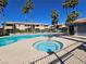 Community pool with spa tub, palm trees, and blue sky at 8410 Eldora Ave # 1053, Las Vegas, NV 89117