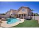 Backyard featuring a pool with spa, artificial turf, and a covered patio at 8507 Titania Ct, Las Vegas, NV 89147