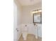 Charming half bathroom featuring a pedestal sink, decorative mirror and neutral color palette at 8507 Titania Ct, Las Vegas, NV 89147