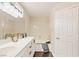 Bathroom with a double sink vanity, decorative lighting, and a tub with shower at 8507 Titania Ct, Las Vegas, NV 89147