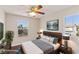 Comfortable bedroom with ample natural light, stylish furnishings, and a ceiling fan at 8507 Titania Ct, Las Vegas, NV 89147