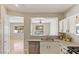 Bright kitchen featuring white cabinets, stainless steel appliances, and an open view to the pool at 8507 Titania Ct, Las Vegas, NV 89147
