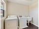 Functional laundry room featuring a washer, dryer, utility sink, and ample space at 8507 Titania Ct, Las Vegas, NV 89147
