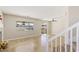 Bright living room featuring tile flooring, staircase, and sliding door access to the backyard at 8507 Titania Ct, Las Vegas, NV 89147