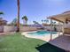 Inviting backyard oasis featuring a private pool, lush landscaping, and a covered patio for outdoor entertaining at 8507 Titania Ct, Las Vegas, NV 89147