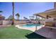 Backyard with a pool and a covered patio with a ceiling fan at 8507 Titania Ct, Las Vegas, NV 89147