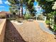 Serene backyard featuring desert landscaping, rock features and covered patio at 8720 Prairie Hill Dr, Las Vegas, NV 89134