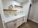 Bar area with wooden shelves for glassware and attractive cabinetry at 8720 Prairie Hill Dr, Las Vegas, NV 89134