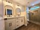 Bright bathroom featuring double vanity with modern fixtures and glass-enclosed shower at 8720 Prairie Hill Dr, Las Vegas, NV 89134