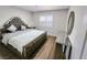Comfortable bedroom featuring hardwood floors, a decorative mirror, and a large bed at 8720 Prairie Hill Dr, Las Vegas, NV 89134