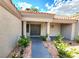 Inviting home entrance featuring double doors, desert landscaping and trimmed plants at 8720 Prairie Hill Dr, Las Vegas, NV 89134