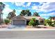 Charming single-story home featuring a two-car garage and desert landscaping with palms at 8720 Prairie Hill Dr, Las Vegas, NV 89134
