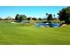 Picturesque golf course view with a tranquil pond and well-manicured greens at 8720 Prairie Hill Dr, Las Vegas, NV 89134