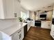 Bright kitchen features white cabinets, stainless steel appliances, and wood-look floors at 8720 Prairie Hill Dr, Las Vegas, NV 89134