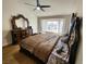 Main bedroom features a decorative headboard, ceiling fan, and bright window views at 8720 Prairie Hill Dr, Las Vegas, NV 89134