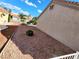 Low maintenance side yard with decorative rock landscaping and a glimpse of nearby condos at 8720 Prairie Hill Dr, Las Vegas, NV 89134