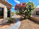 Side yard showcasing desert landscaping and a small garden area at 8720 Prairie Hill Dr, Las Vegas, NV 89134