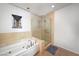 Bright bathroom with soaking tub, tiled walls and glass enclosed shower area at 900 Las Vegas Blvd # 715, Las Vegas, NV 89101